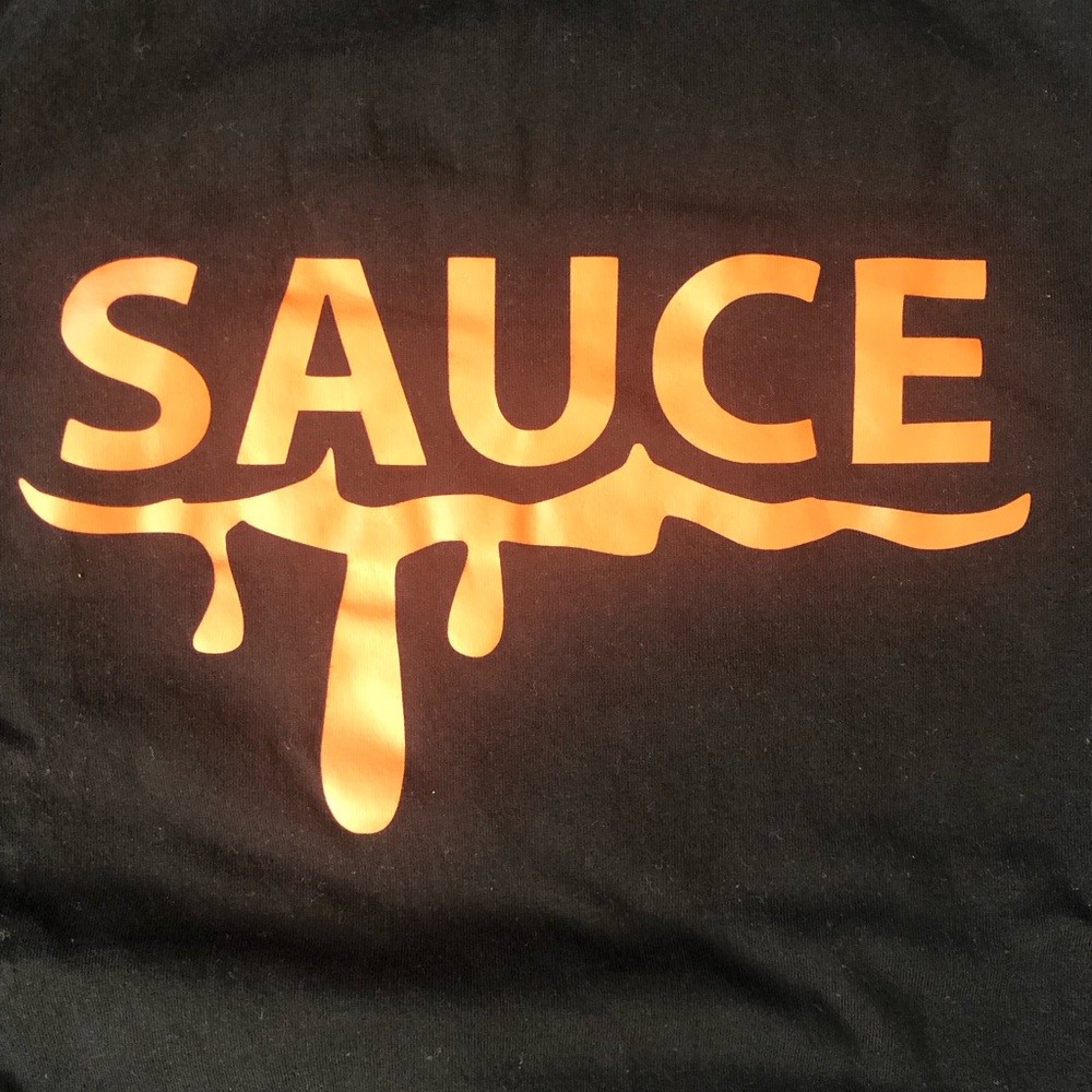 Luxe Black T-Shirt with Bold Orange Graphic that says Sauce. like new condition.